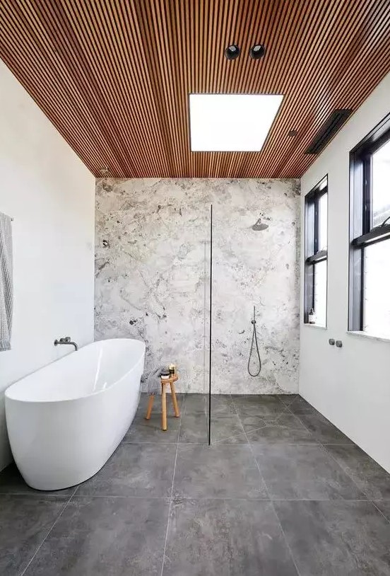 a cute bathroom with a stone accent wall
