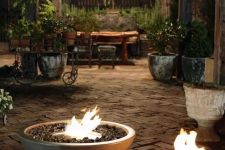 a duo of matching fire bowls with ethanol is a lovely way to illuminate and make your space more welcoming