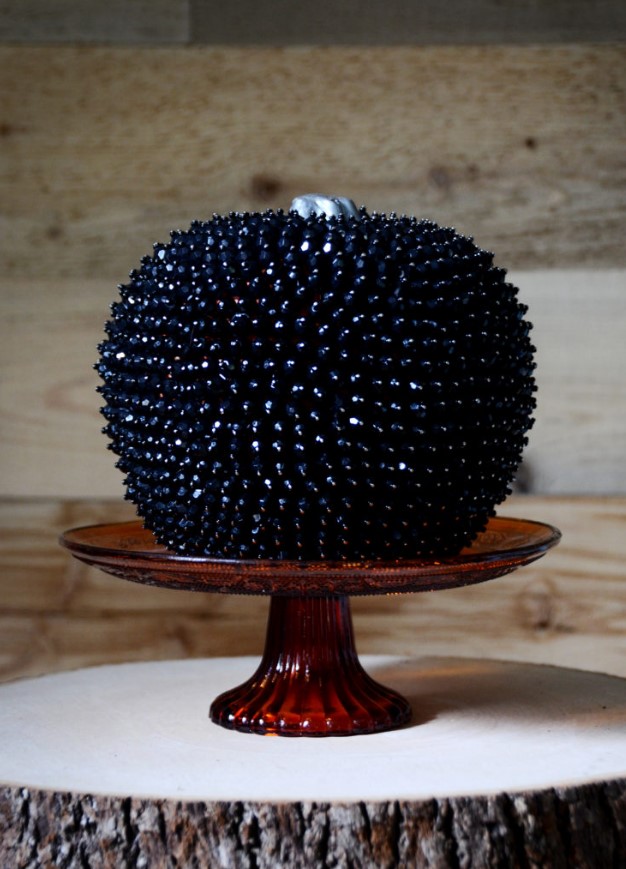 a faux pumpkin fully covered with black beads just wows and will make your Halloween decor jaw-dropping