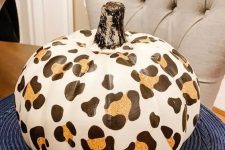 a faux pumpkin with a cheetah print is a bold and trendy idea to decorate your home for the fall
