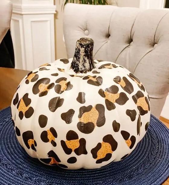 a faux pumpkin with a cheetah print is a bold and trendy idea to decorate your home for the fall