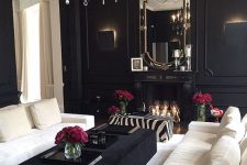 a gorgeous and luxurious living room in black with creamy furniture and a rug to refresh it and touches of metallics and glass to make it more glam