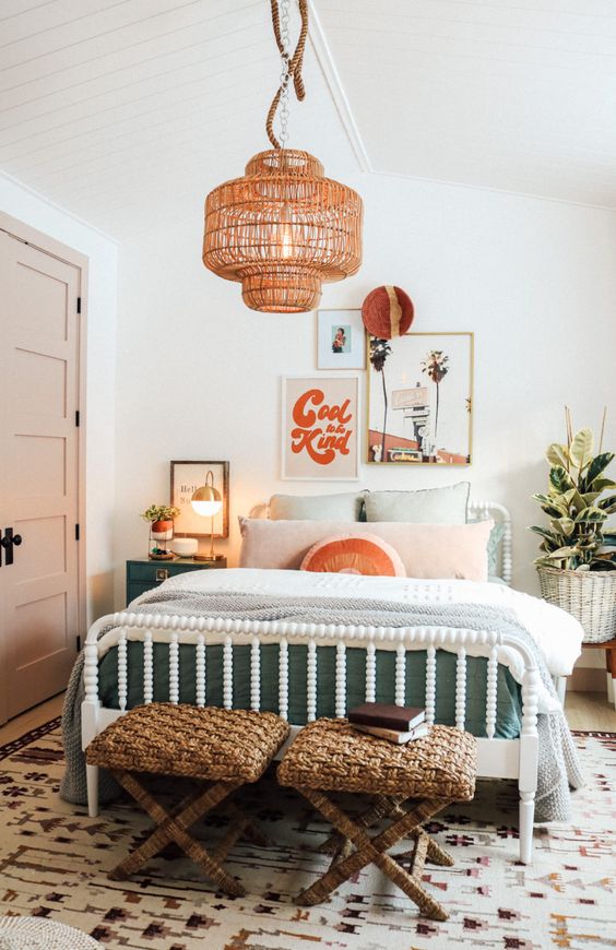 a mid century modern girl bedroom with a white bed and pastel bedding, woven stools, green nightstands, a woven lamp and a gallery wall