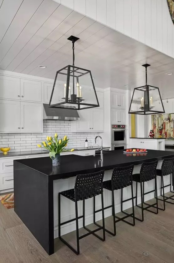 a mid-century modern kitchen with white shaker cabinets, a white skinny tile backsplash, a black and white kitchen island and black woven stools
