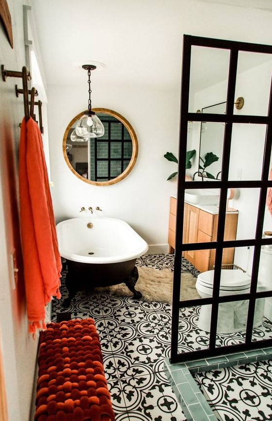 a mid-century modern meets contemporary bathroom done in black and white and accented with coral