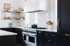 a modern farmhouse black and white kitchen with shaker cabinets, white marble countertops, open shelving, a white hood and a white marble backsplash