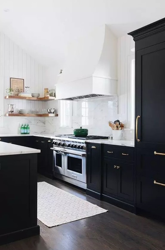 a modern farmhouse black and white kitchen with shaker cabinets, white marble countertops, open shelving, a white hood and a white marble backsplash