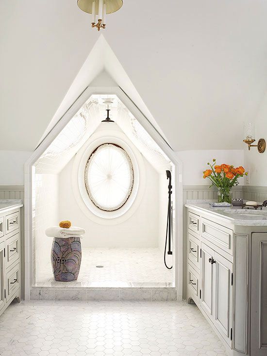 a neutral attic bathroom with marble hex tiles, a doorless shower in the attic niche, neutral farmhouse vanities and brass touches
