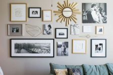 a neutral farmhouse living room with tan walls, a green sofa and a neutral chair, a dark-stained crate table and a catchy gallery wall with black and gold frames