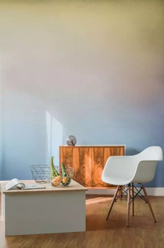 a pretty space with a soft-colored gradient wall, a stained cabinet, a white chair and a storage coffee table is lovely