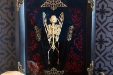 a refined Halloween art piece – a bat skeleton in a coffin and in a refined frame is great for Halloween decor