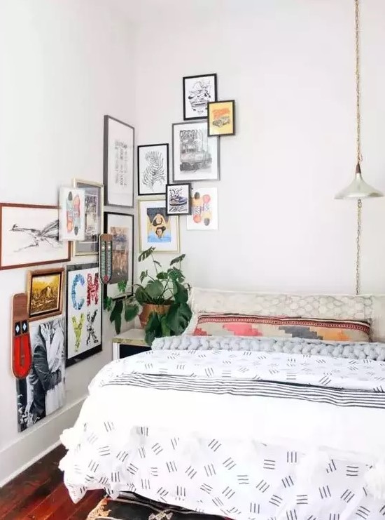 a small bedroom infused with color with printed textiles and a bolc gallery wall that goes to the corner and next wall