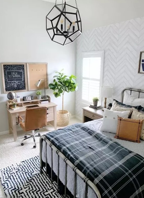 a stylish farmhouse teen room with a metal bed, lots of pillows, a small desk and a leather chair plus a faceted pendant lamp
