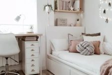 a stylish modern teen girl bedroom in neutrals, with dusty pink touches, lights, a jute rug and potted greenery