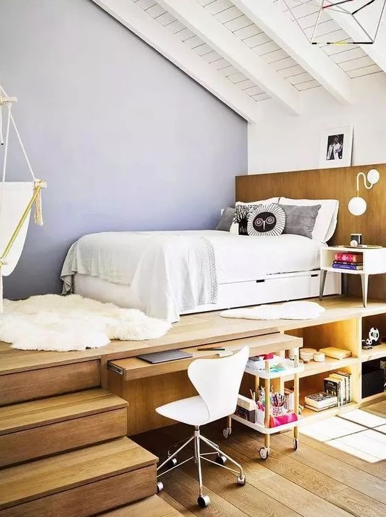 a teen room with a raised platform bed, a built-in desk and storage compartments, a white chair and a suspended chair