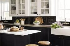 a vintage-inspired kitchen with black shaker cabinets, white countertops and a black Zellige tile backsplash, metal pendant lamps
