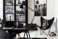 a whimsical black and white home office with black furniture, white as a blank canvas and black and white art