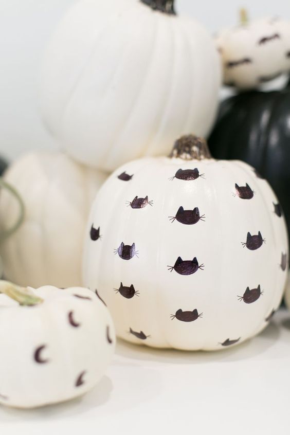 a white faux pumpkin decorated with a black sharpie - with black cats is a simple and lovely idea for Halloween