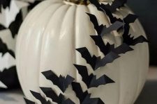 a white pumpkin decorated with black paper bats is a stylish idea for Halloween and will make your absolutely happy with how easy it is to make it