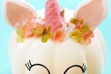a white pumpkin styled as a little unicorn in a floral crown is one of the cutest ideas i have ever seen