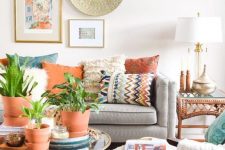 an eclectic living room with terracotta touches, folksy and boho decorations and a unique gallery wall