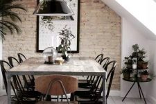 a stylish dining space with a brick wall