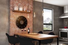 an industrial dining space with a brick accent, a metal and wood table, black chairs and pendant bulbs