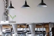 an industrial dining space with grey walls, a vintage stained table, metal chairs and black pendant lamps is a lovely idea to rock
