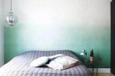 an ombre green statement wall behind the headboard is a peaceful yet catchy touch of color to the bedroom