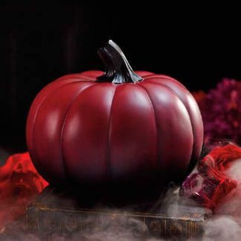 an ombre red to black pumpkin with a black stem is a cool and chic Halloween decor idea to rock
