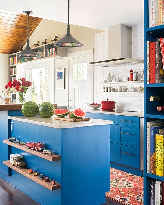 bright sky blue paint on traditional Shaker-style cabinets and a variety of finishes make this eclectic kitchen appealing