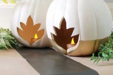 color block white and gold pumpkins with leaf cutouts and candles inside are amazing as fall lanterns
