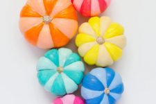 colorful striped rainbow painted pumpkins in brights will be a fun idea not only for Halloween but also for the fall and Thanksgiving