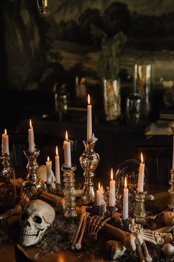 elegant vintage Halloween decor with a skull, skeleton hands, mercury glass candleholders and tall and thin candles is wow