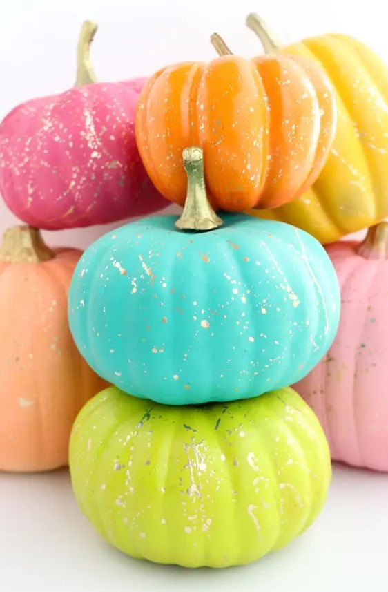 faux pumpkins painted super bright and with gold splatter are amazing and fun for colorful fall decor