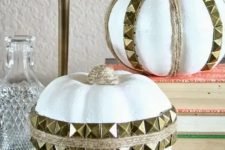 white faux pumpkins with twine and gold spikes attached look fun, rock and glam and will add an edgy touch to the space