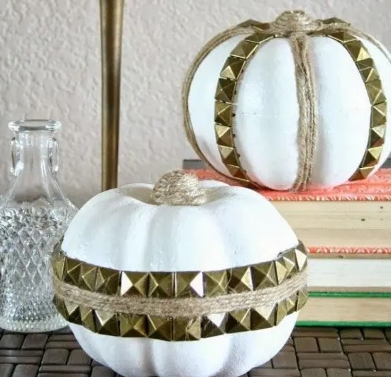 white faux pumpkins with twine and gold spikes attached look fun, rock and glam and will add an edgy touch to the space