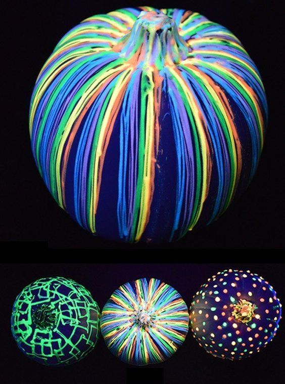 a fun neon Halloween pumpkin decorated with bold glow in the dark paints is a gorgeous idea for your party