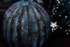 03 a black and navy galaxy pumpkin with tiny white spot stars is a very stylish decoration for Halloween