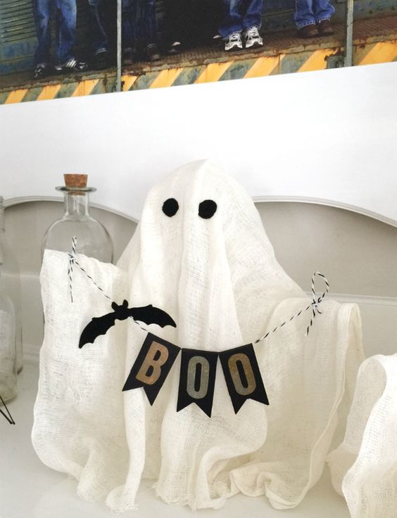 a fun cheesecloth ghost with a banner will be a nice idea for a kids' Halloween party