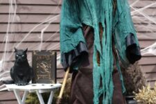 03 a scary faux witch with a black cat is a fantastic indoor and outdoor decoration to pop a Halloween party