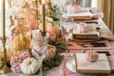 04 a chic glam Thanksgiving table setting with pink placemats, vintage books, pastel pumpkins and blooms, tall candles