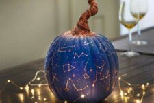 05 a bright blue Halloween pumpkin with gold constellations and a whimsical wrapped stem is a catchy and lovely idea