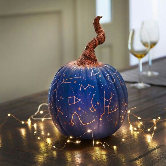 a bright blue Halloween pumpkin with gold constellations and a whimsical wrapped stem is a catchy and lovely idea