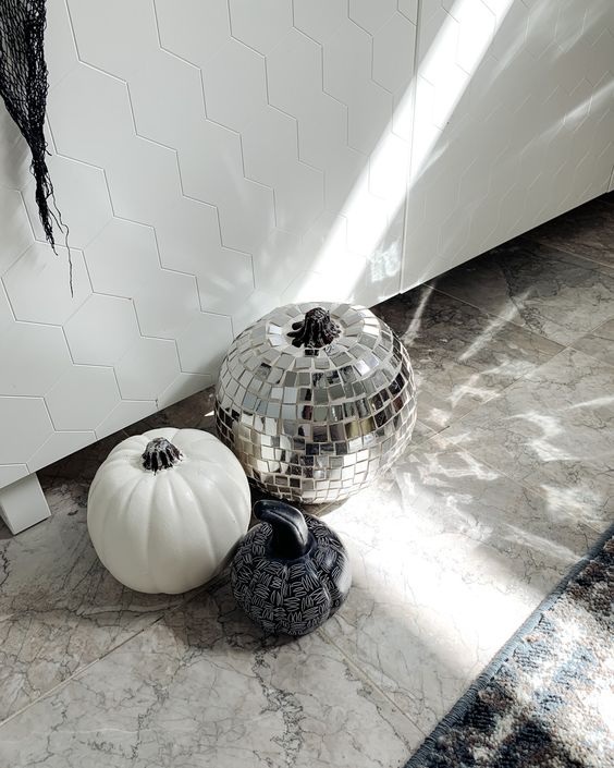 modern Halloween pumpkins - a white one, a black and white sharpie one, a disco ball one for a bold party