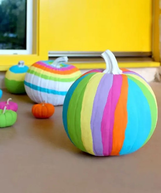 bold and colorful striped neon pumpkins are amazing for decorating a space for Halloween and look gorgeous