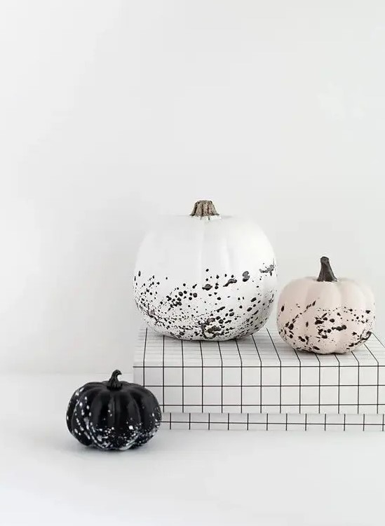 gorgeous modern Halloween pumpkins - a white, black and blush one with splatters are awesome