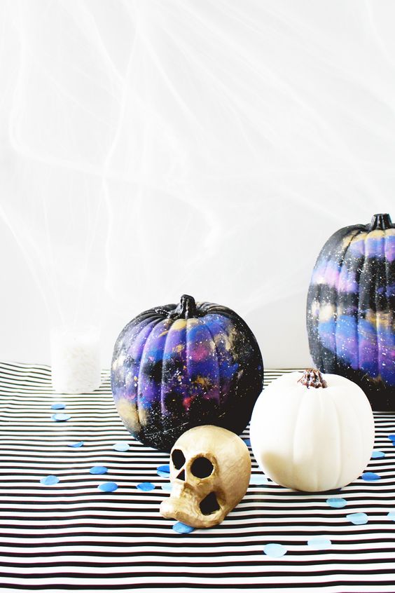 black, purple and gold galaxy-themed pumpkins are amazing for Halloween, bold, catchy and mysterious