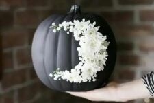 go for creative art decorating your matte black pumpkin with white blooms like that – this isn’t a durable decoration but a very cool one