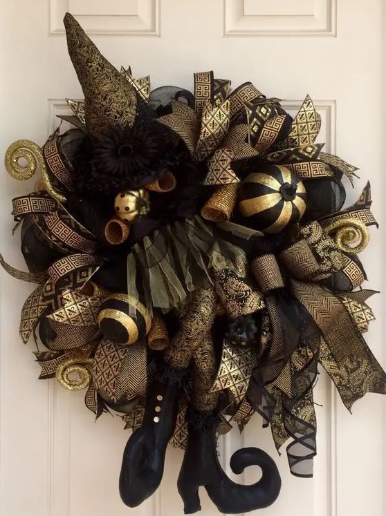 an elegant black and gold witch wreath for Halloween front door decor in a chic and stylish color scheme